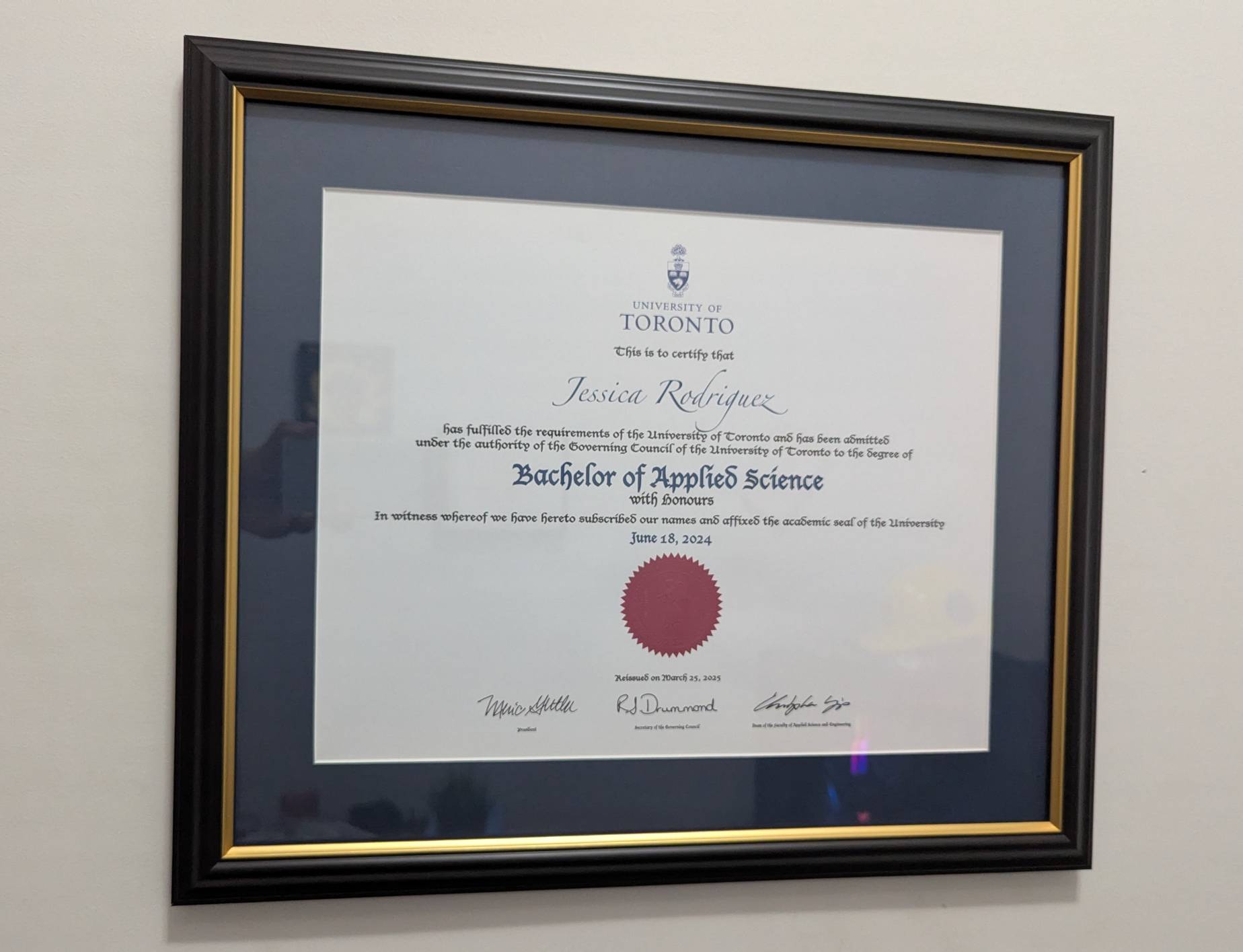 My diploma, framed and mounted on the wall. The degree is a Bachelor of Applied Science with honours from the University of Toronto, dated June 18, 2024.
